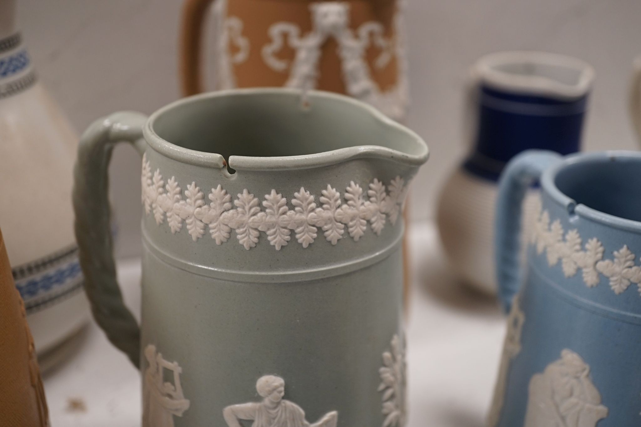 A collection of Dudson stoneware, including jugs, teapots, cream jugs etc, many decorated in low relief